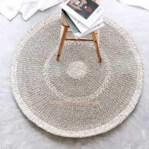 Round seagrass rug with a natural woven pattern, made in Vietnam