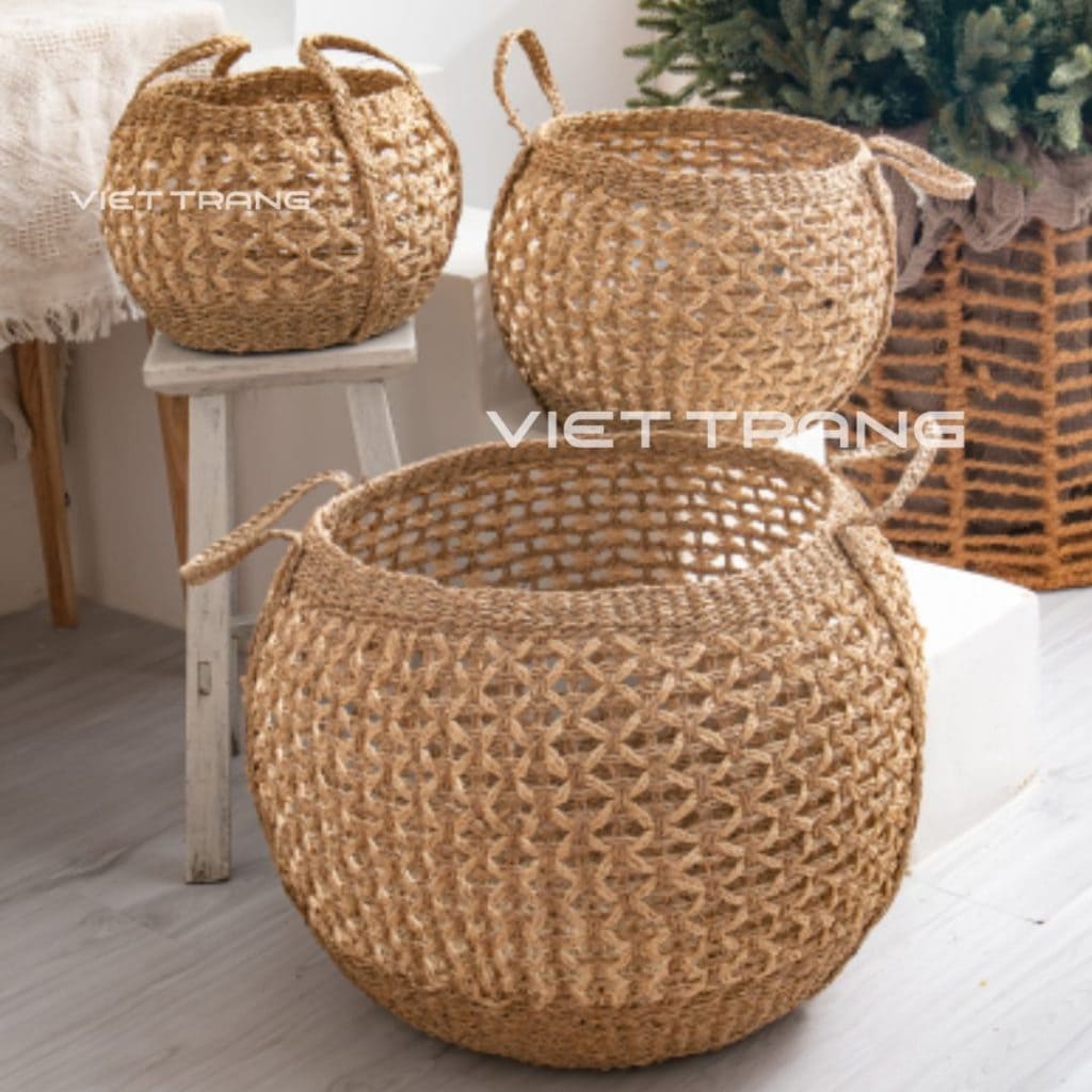 Seagrass belly baskets displayed in a bright room, handwoven in Vietnam.