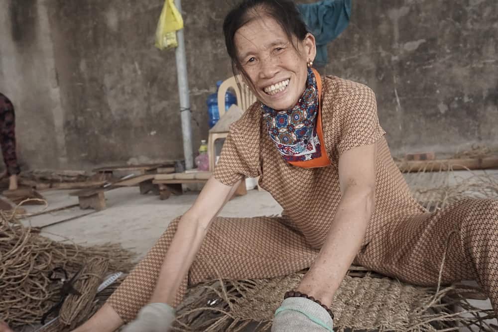 What SMETA and BSCI Mean When You Source from Vietnam 3 A smiling Viet Trang weaver at work with seagrass in Vietnam.