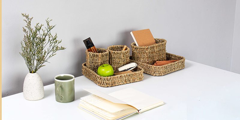 Seagrass desk organizer trays holding stationery, handwoven in Vietnam.