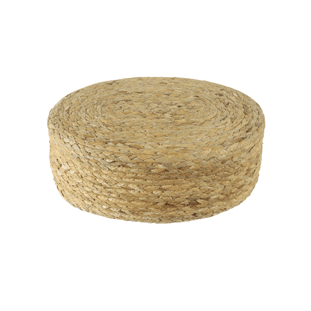 Round woven water hyacinth ottoman seen from the side on a white background