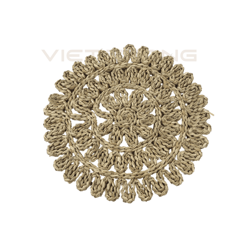 Open work seagrass placemat woven in a round flower pattern, handmade in Vietnam.